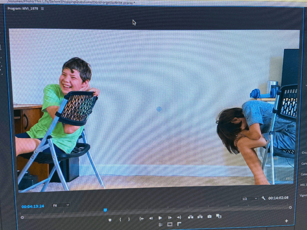 Two boys sitting in chairs & laughing
